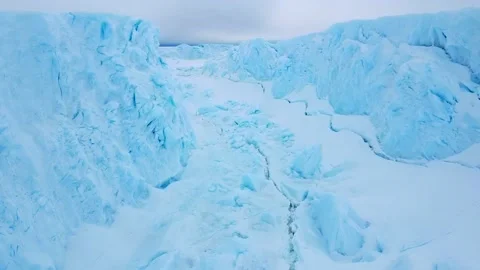 Snow covered antarctic surface aerial view flight. Stock Footage 224494547