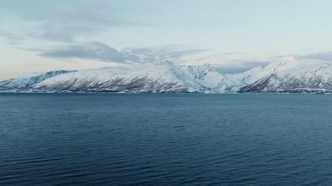 Snow Covered Arctic Mountains Rising Beyond Deep Blue Fjord Stock Footage 337974086