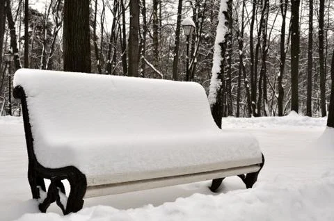 Snow covered bench Stock Photos