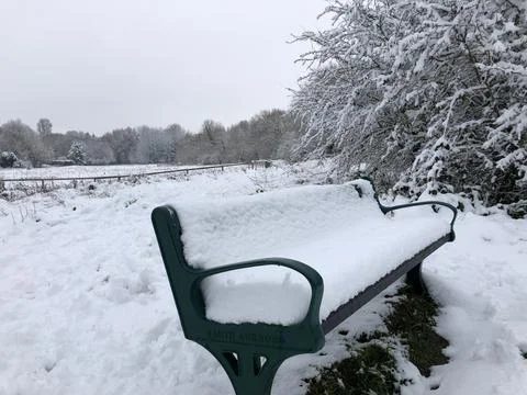 Snow covered bench Stock Photos
