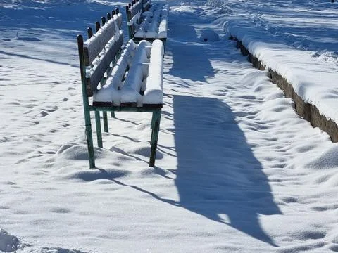 Snow-covered benches Stock Photos