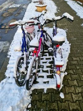 Snow-Covered Bicycles on a Winter Day Stock Photos
