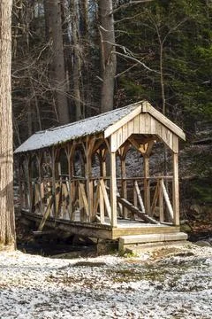Snow covered bridge spanning willard brook Stock Photos