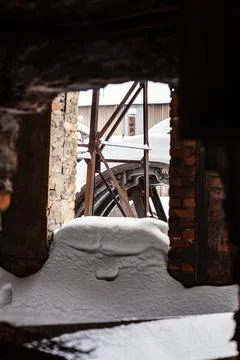 Snow-covered broken window on abandoned factory Stock Photos