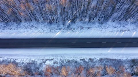 Snow-covered bypass road surrounded by trees. The concept of transport Stock Footage 165382808