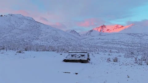 Snow covered camper van parked in remote Andes wilderness during winter camping Stock Footage 336659098