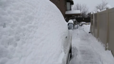 Snow covered car and house Stock Footage
