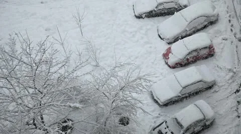 Snow covered cars at the parking lot and snowfall Stock Footage