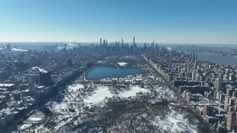 Snow Covered Central Park Pull Back Ascend With Midtown Skyline Behind Stock Footage 344752863