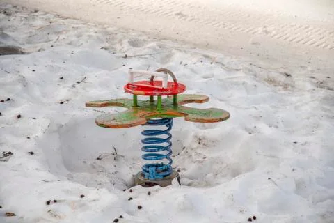 Snow-covered children's playground and playground equipment in snow Stock Photos