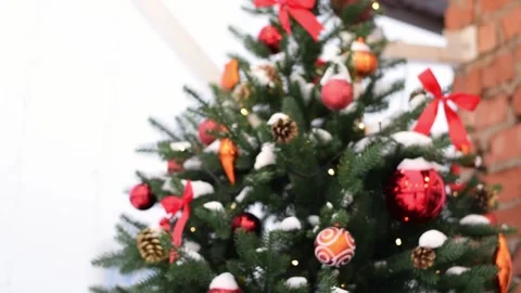 A snow-covered Christmas tree with red decor. Stock Footage 165580744