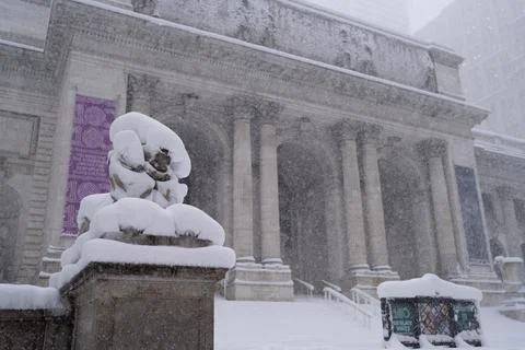 Snow covered classical building facade in heavy snowfall Photos