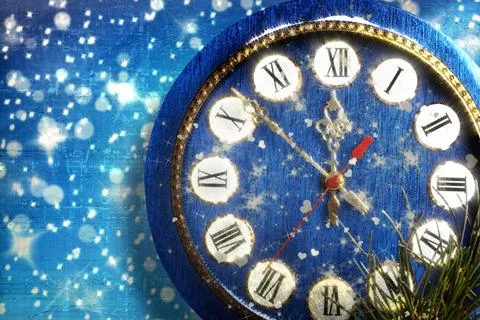 Snow-covered clock on  blue background Stock Photos