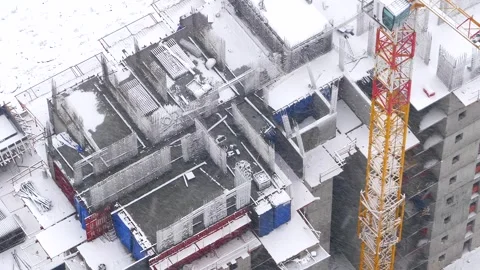 Snow covered construction site in winter storm - Cold Weather and Crane Texture Stock Footage 339809764