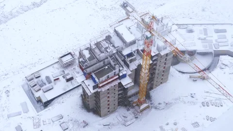 Snow covered construction site in winter storm - Urban Worksite and Cold Weather Stock Footage 339809796