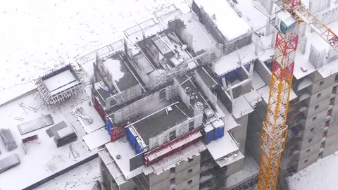 Snow covered construction site in winter storm - Cold Weather and Crane Detail Stock Footage 339809863