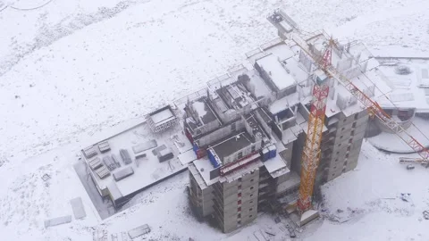 Snow covered construction site in winter storm - Building Detail and Tower Crane Stock Footage 339809872
