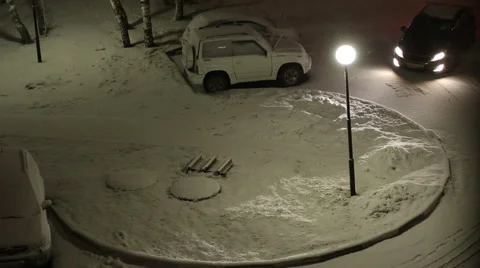 Snow-covered courtyard at evening. View from the window Stock Footage 56814428