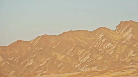 Snow-Covered Danxia Mountains Distant Peaks Sunset B-Roll Stock-Footage 325868745