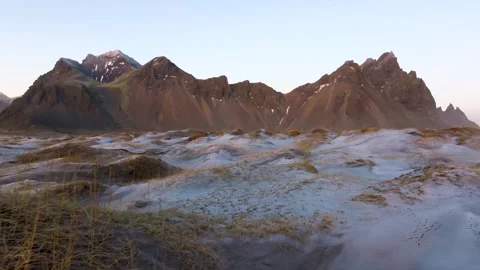 Snow covered dunes and distant mountains beneath a clear sky Stock-Footage 341328068