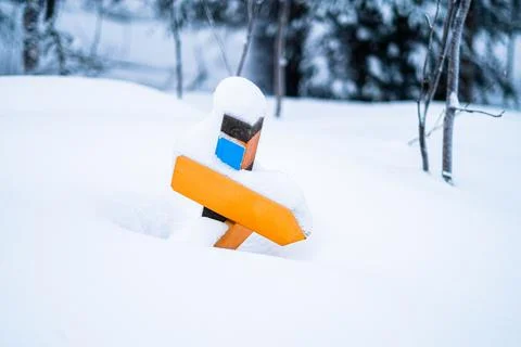 Snow Covered Empty Direction Sign Guiding the Path in the Snow Stock Photos