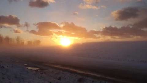 Snow covered farm road at sunset Stock Footage