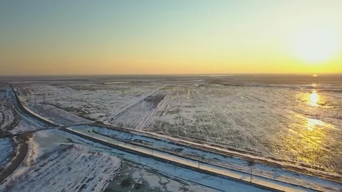 Snow-covered fields at sunset from a bird's eye view Stock Footage 123101841
