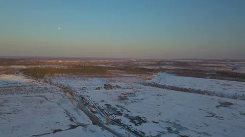 Snow-covered fields at sunset from a bird's eye view Stock Footage 123101941