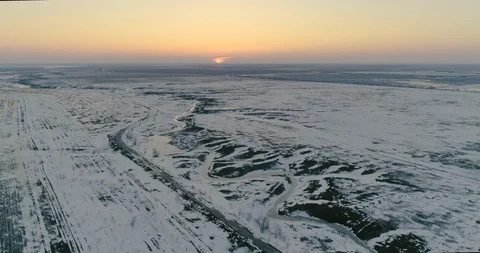 Snow-covered fields at sunset from a bird's eye view Stock Footage 123102642