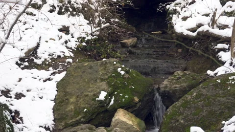 Snow Covered Forest Stream with Large Stones Stock Footage 147550289