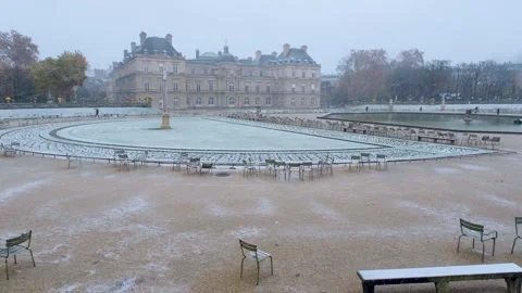 Snow Covered gardens ans Senate in Luxembourg Gardens Stock Footage 317675778