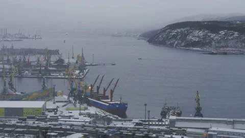 Snow-covered hillside on the backdrop of the gulf and port. Stock Footage 143215325
