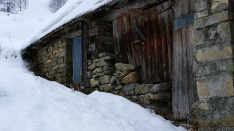 Snow covered house on mountain during snowfall Stock Footage 64861003