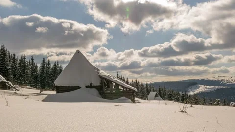 Snow covered house in the mountains in a cloudy winter day Stockbeeldmateriaal 172207006