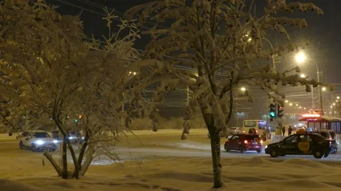 A snow-covered  intersection and people crossing the road. Stock Footage 155029427