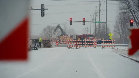 Snow-covered intersection is blocked by construction barriers and warn Stock-Footage 327251019