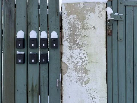 Snow covered key lock boxes on apartment rental wall Stock Photos