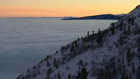 Snow Covered Landscape with Blanket of Cloud Inversion at Sunset - Tilt Up Stock Footage 99436418