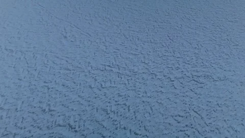 Snow-covered landscape with intricate patterns and textures visible on the Stock Footage 331755168