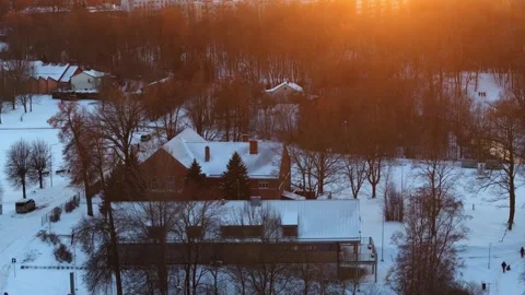 Snow Covered Landscape with Red Brick Building at Sunset Stock Footage 300506736