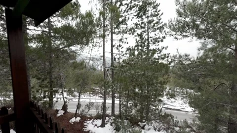 Snow-covered landscape viewed from a cabin balcony Stock Footage 301599321