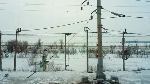 Snow-covered landscape is visible from the window of a passing train Stockbeeldmateriaal 220444349