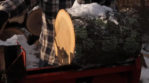 Snow covered log being split Stock Footage 1008933