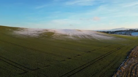 Snow covered meadow with glowing under the warm light of the setting sun Stock Footage 300784656