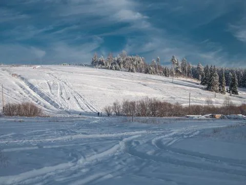 Snow-covered meadows and forest at the hill in the valley of the Stone Hill p Stock Photos
