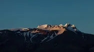 Snow Covered Mountain With Alpineglow Against Blue Sky During Sunset Stock Footage