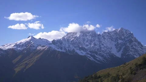 Snow covered mountain with clouds in the foreground, close-up 스톡 동영상 190702437