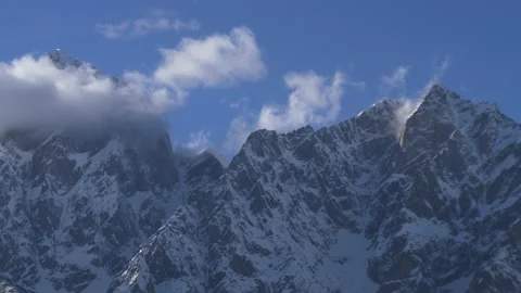 Snow covered mountain with clouds in the foreground, close-up Stock-Footage 190703920