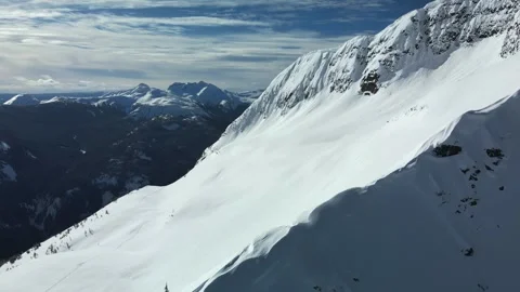 Snow covered mountain landscape in the winter, drone shot Stock Footage 289575925