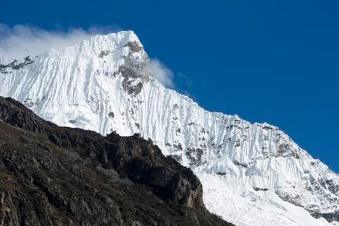 Snow covered mountain peak and blue sky, Cordillera Blanca, Peru Stock Photos